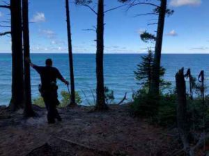 Hiker overlooking Lake Superior in the Painted Rocks National Lake Shore.